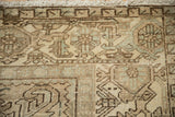 Close-up of the worn knot heads and samovar turtle design on a vintage Mehrivan rug.