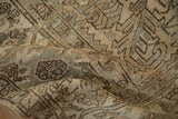 Detailed texture of the distressed, low pile on a vintage Mehrivan carpet with geometric motifs.