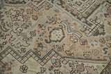 Worn vintage Heriz carpet pile with geometric blossoms in sand, pale blue, and charcoal.