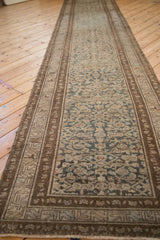 Distressed Hamadan runner's intricate Herati pattern in darker teal and brown tones.