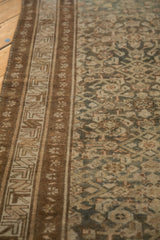 Close-up of distressed Hamadan runner border with geometric patterns and worn teal, brown Herati motifs.