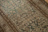 Distressed vintage Hamadan runner showing intricate Herati pattern, dusty teal, and chocolate tones.