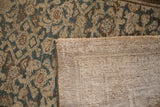 Hand-knotted reverse weave and distressed Herati pattern in teal, brown, and ivory.