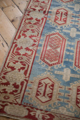 Vintage Oushak runner: cherry red continuous vine border, sky blue cartouche field.