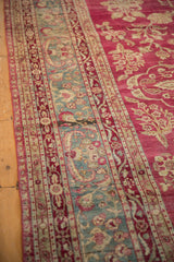 Jade green border with European-influenced floral sprays on a distressed antique Yezd carpet.