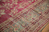 Close view of an antique Yezd's hand-knotted pile with raspberry, jade, and ivory floral details.