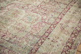 Texture of an antique Kerman showing mostly even wear and raspberry red floral details.
