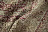 The soft drape of a distressed antique Kerman rug, revealing its time-softened, low-pile texture.