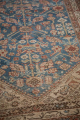 Even wear across the knot heads of an antique Malayer rug with a blue and copper blossom design.