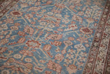 A close view of the low pile texture and interconnected blossom design on an antique Malayer rug.
