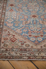 Close-up view of the even wear and detailed boteh border on an antique Malayer rug runner.