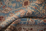 Low, even pile showing hand-knotted texture and blossom motifs on an antique Malayer rug.