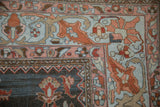 Lilihan carpet corner displaying powder blue border with terra cotta floral arabesques and wear.