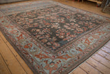 Distressed Lilihan carpet corner with fluid powder blue border and terra cotta arabesques.