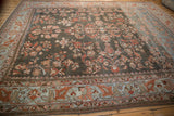 Distressed Lilihan carpet features powder blue arabesque border and faded charcoal floral field.
