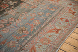 Distressed Lilihan carpet corner with powder blue abrashes, floral field, and arabesque border.