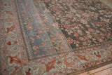 Distressed Lilihan carpet corner showing floral field, fluid border, and powder blue to charcoal abrash.