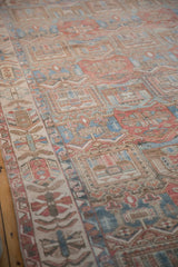 Distressed vintage Bakhtiari rug showing soft ruby red and sky blue garden motifs.