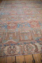 Distressed Bakhtiari carpet border detail with faded floral motifs and short fringe.