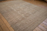 Distressed vintage Ersari carpet showcasing tone-on-tone camel and sand geometric gul patterns.