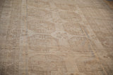Distressed vintage Ersari carpet texture with floral guls, camel and sand abrashes, faint foundation.