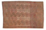 A distressed vintage Ersari carpet with columns of guls on an abrashed field of blush pink and dusty blue.