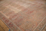 Angled perspective showing the heavy abrashes and color shifts on a distressed vintage Ersari carpet.