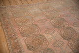 Worn pile and heavy color abrashes across the geometric gul pattern of a vintage Ersari rug.