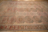 Abrasions and color variation across the geometric gul motifs and main border of the vintage Ersari carpet.