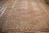 Angled perspective of a vintage Ersari carpet showing its column of guls and heavy color abrashes.