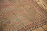 Detailed view of a vintage Ersari carpet showing the evenly worn low pile and abrashed blush tones.
