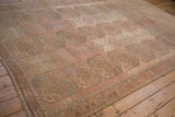 Angled view of a vintage Ersari carpet highlighting the abrashed field and geometric gul design.