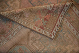 Folded corner of a vintage Ersari rug showing its machine-bound side and low, worn pile.