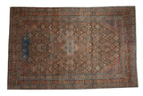 Distressed vintage Joshegan carpet, central medallion, brown field, sapphire blue and madder red.