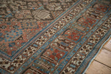 Distressed vintage Joshegan carpet pile showing powder blue and madder red border patterns.