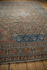Distressed Joshegan carpet border with geometric patterns in sapphire blue and madder red.