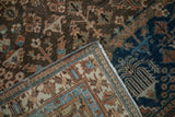 Distressed Joshegan carpet corner revealing hand-knotted reverse, fringe, and machine-bound side.