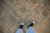 Vintage distressed Ersari carpet displaying sand, dusty blue guls, heavy abrashes, and even wear.
