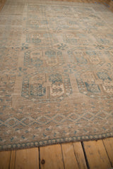 Distressed Ersari rug's machine bound side, showing geometric pattern and abrashed sandy beige tones.