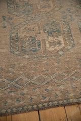 Textural distressed vintage Ersari carpet pile with abrasions in sand, beige, and dusty blue.