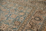 Distressed Malayer carpet's worn pile, continuous vine, palmette border, dusty teal and coral.