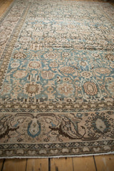 Distressed Malayer carpet border detail, with muted blue, brown, and ivory palmette design.