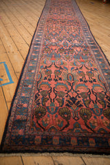 Side angle view of the Persian Lilihan runner's blush floral field and navy border.