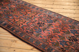 An angled view along the vintage Lilihan runner's length, showing its plush floral pile.