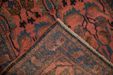 Corner of vintage Lilihan rug folded over to show the hand-knotted weave and plush pile.