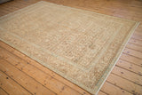 Distressed vintage Hamadan carpet corner, showing geometric Herati design in cream, gold, powder blue.