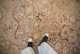 Distressed vintage Kayseri carpet with even wear, faded red, sand, and delicate floral motifs.
