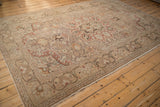 Distressed Kayseri carpet corner revealing elegant arabesque border and faded traditional motifs.