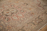 Distressed Kayseri carpet border with dramatic arabesques, serrated leaves, faded red, sand, and brown.