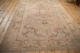 Distressed vintage Kayseri rug with dramatic arabesque border and time-softened floral field.